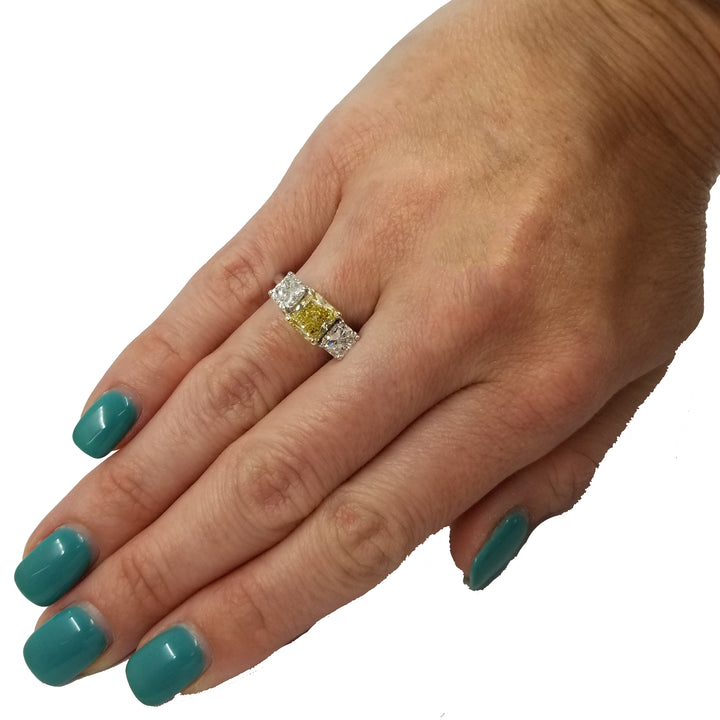 Fancy Intense Yellow Diamond Ring with Two Radiant Diamonds